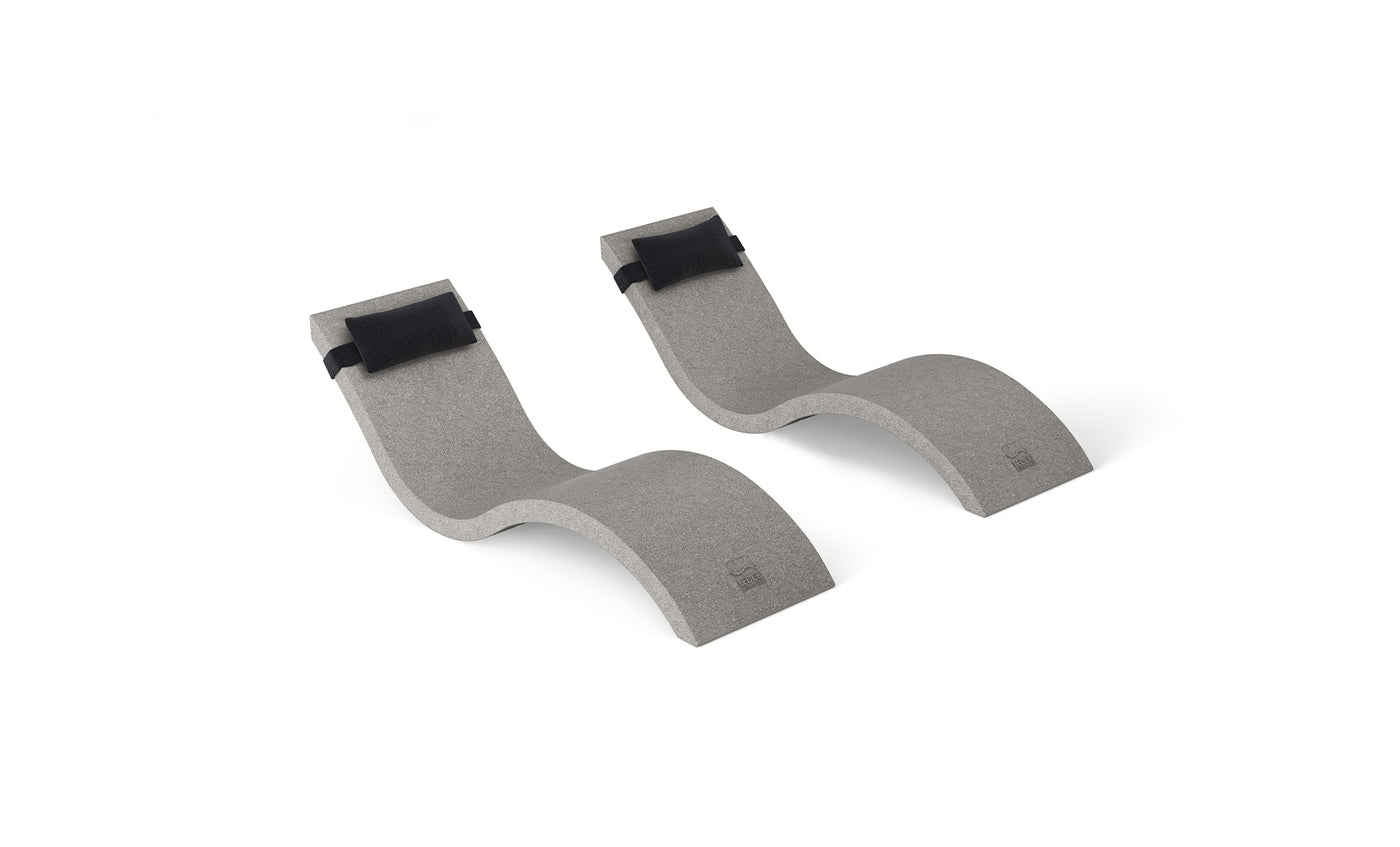 The Outdoor Escape In-Pool Furniture Bundle by Ledge Lounger includes two curved gray foam blocks with black adjustable straps, each featuring an S-shape design that mirrors the elegance of a chaise lounge, offering stability and support for diverse fitness activities.
