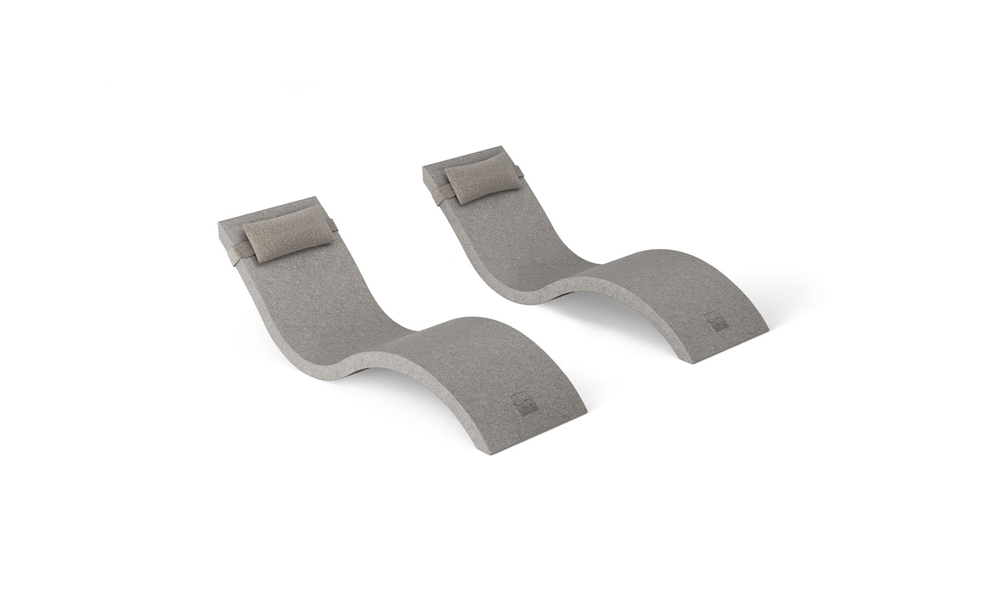 The Outdoor Escape In-Pool Furniture Bundle by Ledge Lounger includes two gray chaise lounges with integrated headrest pillows, offering a smooth, ergonomic design perfect for any outdoor setting. Set against a plain white backdrop, they complement any modern outdoor furniture collection.