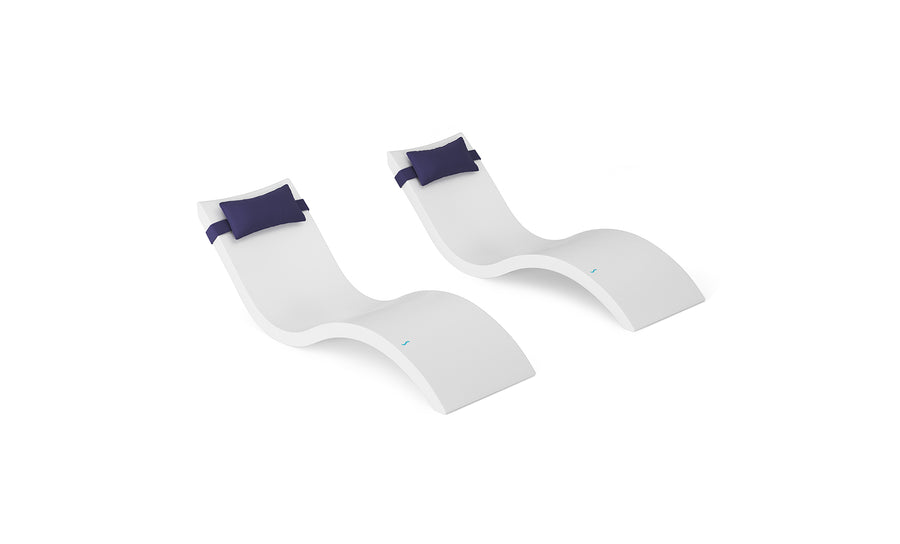 The Ledge Lounger Signature Chaise and Headrest Pillow In-Pool Set features two modern white chaises with curved designs and detachable dark blue pillows—ideal for crafting your perfect outdoor escape.