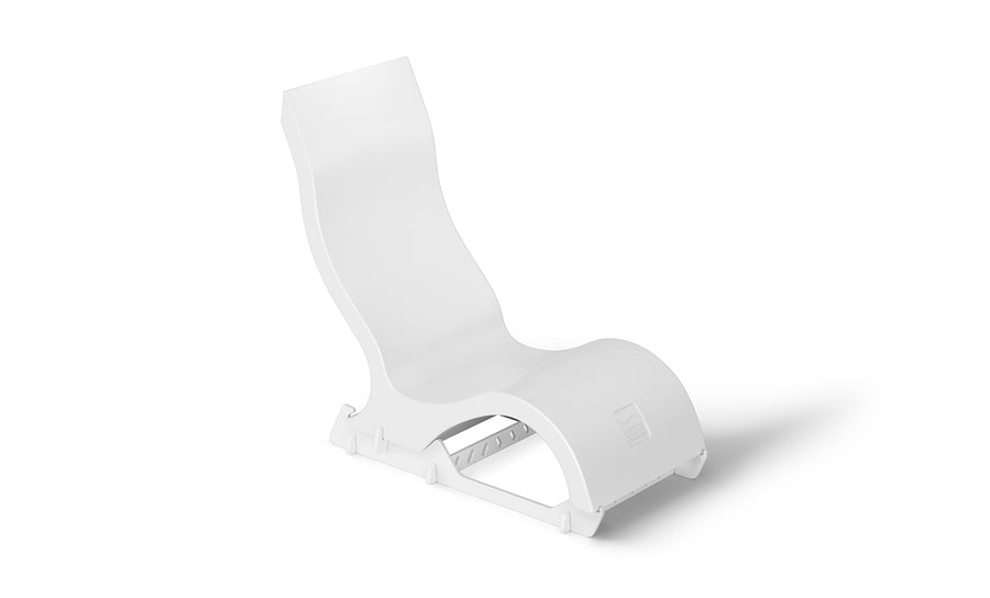 The Signature Chair Riser by Ledge Lounger is a modern, minimalist white lounge chair with a curved design. It has a smooth, wavy silhouette and sturdy base, making it ideal for outdoor relaxation or chic in-pool seating.