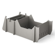 The Signature Chair Riser by Ledge Lounger is a gray, rectangular plastic organizer featuring multiple compartments and dividers. Its minimalist, modular design perfectly complements any workspace, just as in-pool seats enhance an outdoor day against a pristine white background.