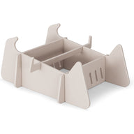 A beige, rectangular modular desk organizer with open compartments and vertical dividers, made from flat interlocking panels—perfect for organizing paperwork after a day relaxing on Ledge Lounger Signature Chaise Deep Riser.