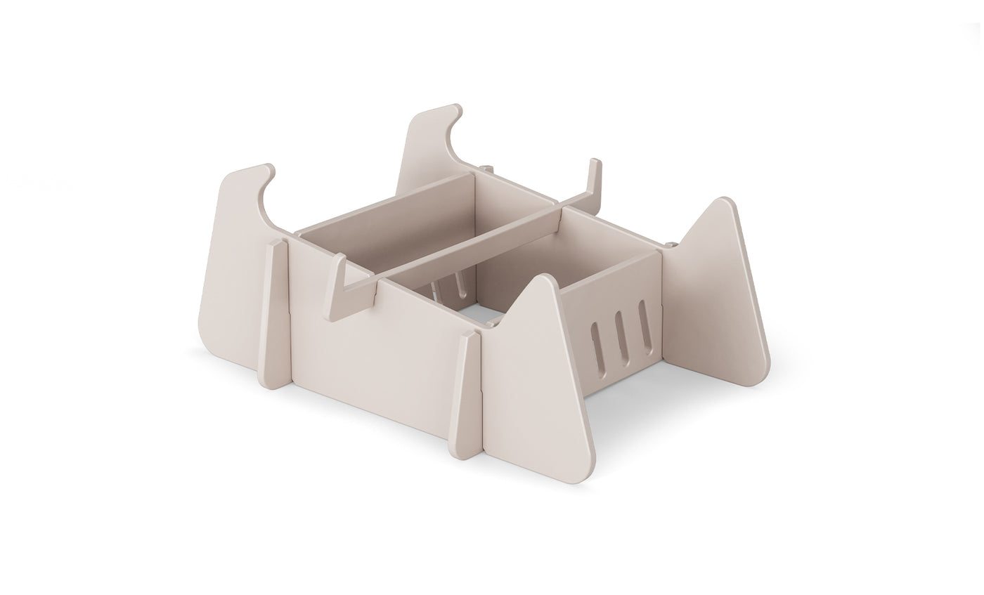 A beige, rectangular modular desk organizer with open compartments and vertical dividers, made from flat interlocking panels—perfect for organizing paperwork after a day relaxing on Ledge Lounger Signature Chaise Deep Riser.