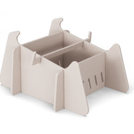 A beige, flat-pack, rectangular organizer with side panels and divided compartments, inspired by minimalist animal shapes—ideal for storing essentials after a day outdoors by your Ledge Lounger Signature Chaise Deep Riser or in-pool seats. Placed on white background.
