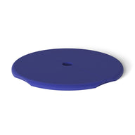 The Ledge Lounger Signature Side Table Lid features a smooth, round blue disc design with a slit from center to edge and a central hole for an umbrella pole, plus subtly raised edges.