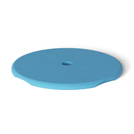 The Ledge Lounger Signature Side Table Lid with Umbrella Hole is a round, blue cover featuring a central hole and a groove across its diameter, set against a white background.