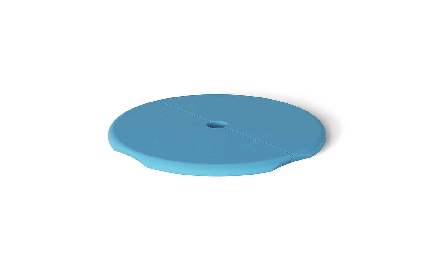 The Ledge Lounger Signature Side Table Lid with Umbrella Hole is a round, blue cover featuring a central hole and a groove across its diameter, set against a white background.