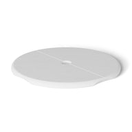 The Ledge Loungers Signature Side Table Lid with Umbrella Hole is a white, round, flat object featuring a subtle groove across its diameter. Resting against a plain white background, its an essential poolside necessity for any outdoor scene.