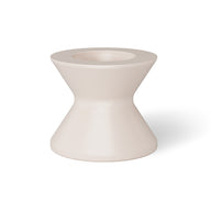 A white, hourglass-shaped vase with a narrow center and wide opening elegantly sits on the Signature Tall Ice Bin Side Table by Ledge Lounger, its matte finish catching the light and casting a shadow to the right.