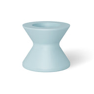 The Signature Tall Ice Bin Side Table by Ledge Lounger is a light blue, hourglass-shaped ceramic stool with a smooth surface, wider top and base tapering elegantly toward the center, and featuring a small circular indentation on top.