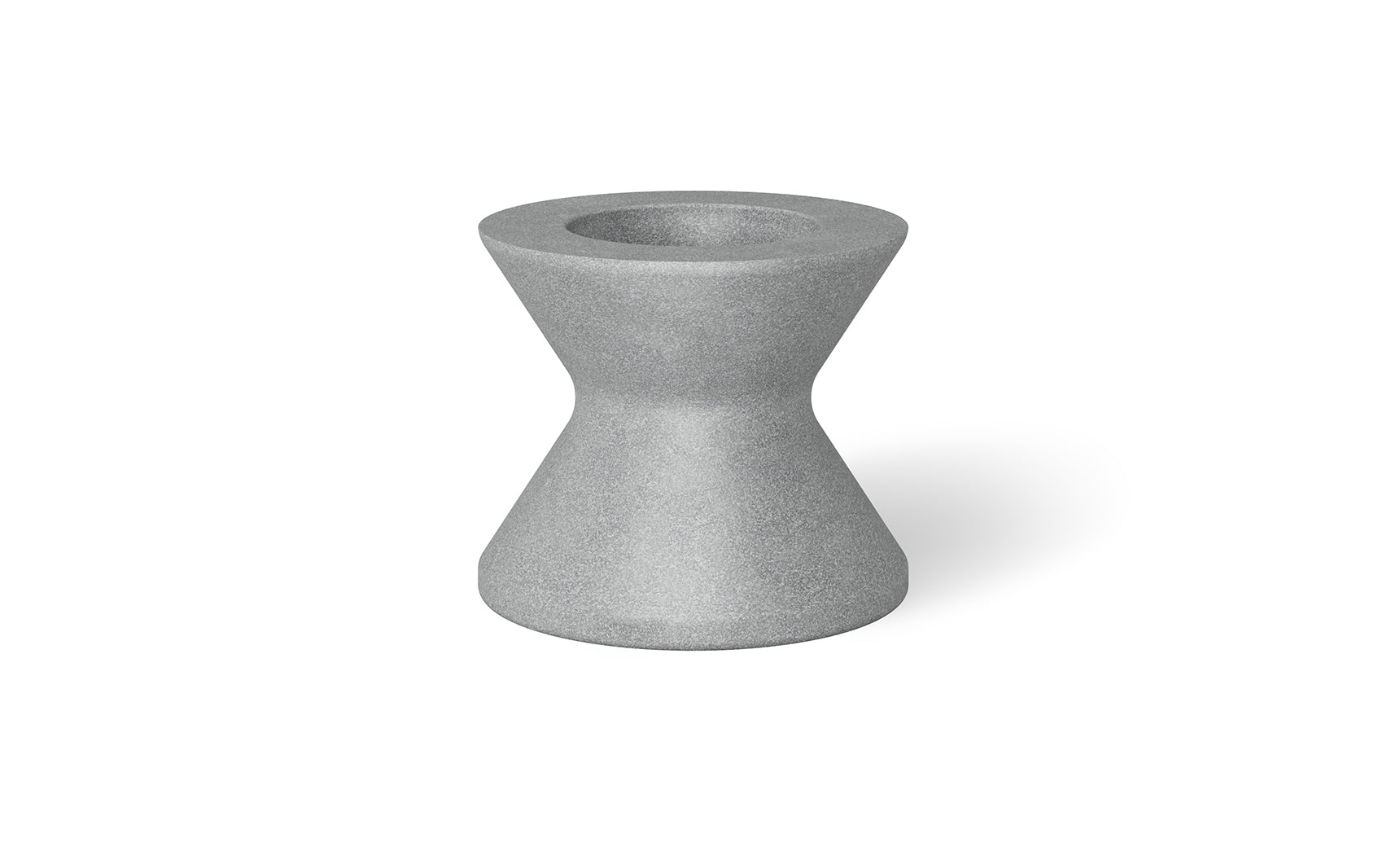 A small, hourglass-shaped gray object with a hollow top resembles an umbrella base. Its smooth surface and symmetrical design remind one of an industrial component. Shadows imply placement on a light surface, akin to the Signature Tall Ice Bin Side Table by Ledge Lounger.