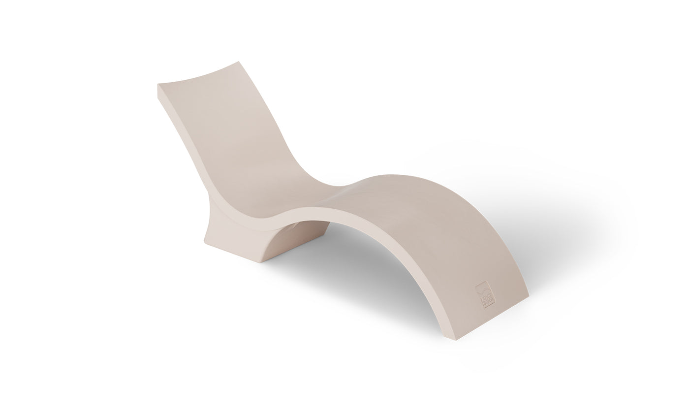 The Ledge Lounger Signature Chaise Deep is a modern cream-colored, S-shaped lounge designed for pool tanning ledges, perfect for relaxation on a white backdrop.