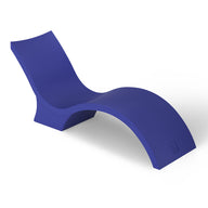 The Signature Chaise Deep by Ledge Lounger is a sleek, modern lounge chair with a minimalist wave design in bold blue. Its smooth, curved form creates a contemporary look, perfect for relaxing on the tanning ledge or adding flair against a plain white background.