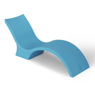 The modern Signature Chaise Deep by Ledge Lounger boasts a sleek, curved design in blue with an undulating shape like a sun shelf on a tanning ledge, all set against a plain white background.