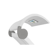 A close-up of the Signature Chaise Shade by Ledge Lounger showcases a sleek, modern white lamp with a flexible curved arm, perfect for media viewing. The head features an LED display, and the gray-accented joints display LEDX Expert in small text.