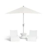 A sleek white patio setup includes two modern chairs, a Signature Standard Side Table by Ledge Lounger, and a large white umbrella. Its minimalist design is ideal for in-pool use on your sun shelf.