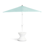 The open Signature Tall Ice Bin Side Table by Ledge Lounger showcases a light blue patio umbrella with a sturdy white stand and rounded, hourglass-shaped base that doubles as an ice bin side table. Set against a plain white background, the lid is designed to be removable.