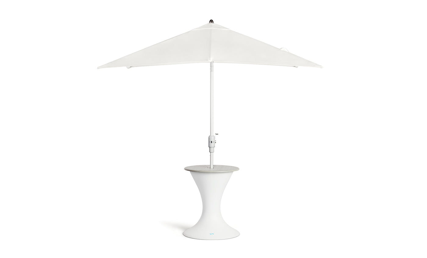 The Ledge Lounger Autograph Umbrella Stand Ice Bin boasts a tall, sleek white design with a round, hourglass-shaped base for stability. It features a minimalist central pole and triangular canopy, perfect for enhancing the modern aesthetic of your outdoor relaxation area.