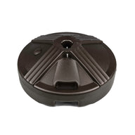 The Ledge Lounger Resin Coated Concrete Umbrella Base boasts a black, circular, textured surface and is perfect for center pole umbrellas. It secures the umbrella with a central hole, enhancing any outdoor dining setup.