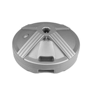 The Ledge Lounger Resin Coated Concrete Umbrella Base features a round, grey plastic design with geometric grooves and a central hole, perfect for center pole umbrellas. Its smooth surface has a raised circular section and side opening to enhance outdoor dining experiences.