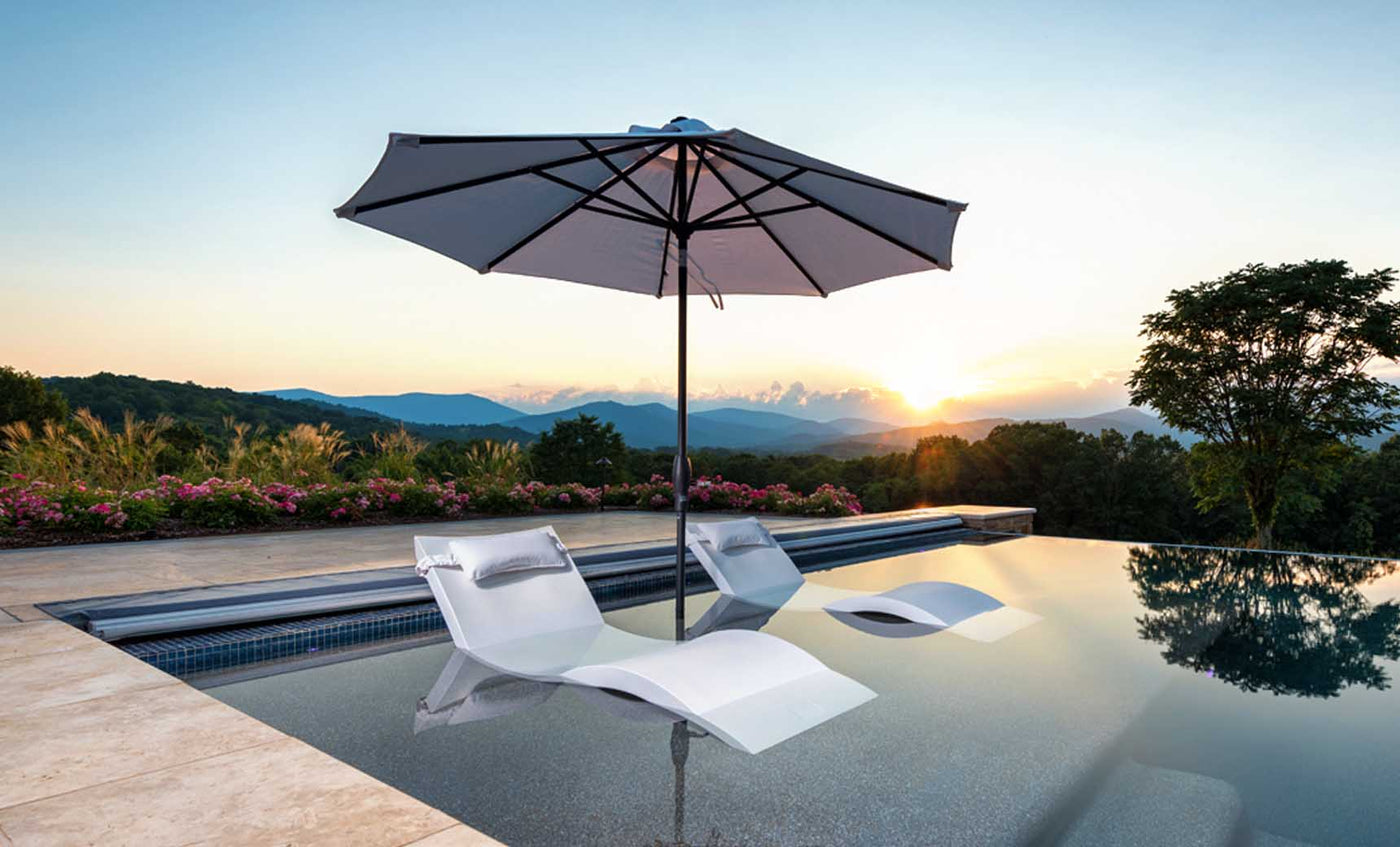 Ledge Lounger in-pool umbrella and chaises.