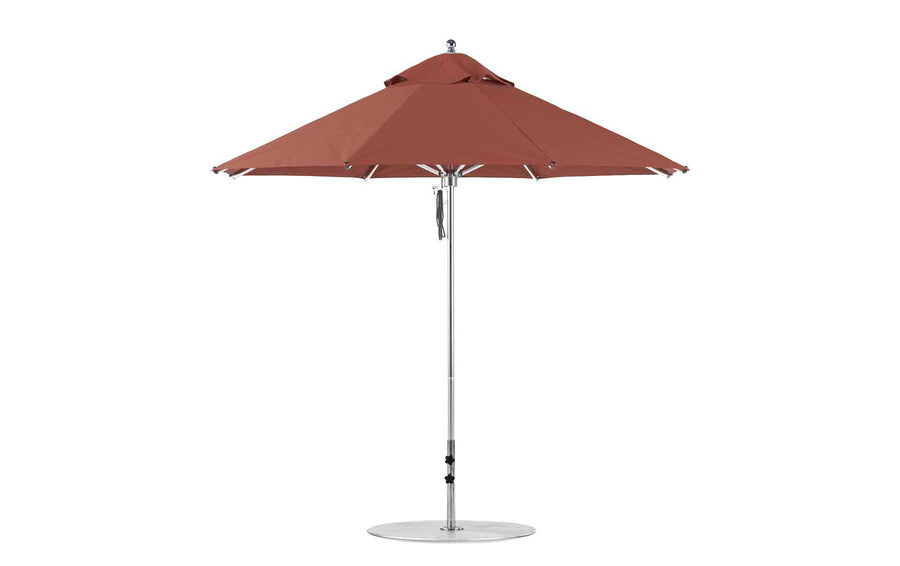 The Ledge Lounger Premier Aluminum Umbrella - 9 Octagon Pulley, in red, features a sturdy central pole and metal base. Its large canopy ensures shade with vented sections for airflow. Made from marine-grade fabrics, this wind-resistant umbrella is perfect for any outdoor patio setting.