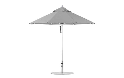 The Ledge Lounger Premier Aluminum Umbrella features a 9 octagon round canopy in gray marine-grade fabric, supported by a white metal pole with a circular base. Its symmetrically designed wind-resistant structure is fully open, showcasing robust and durable construction.