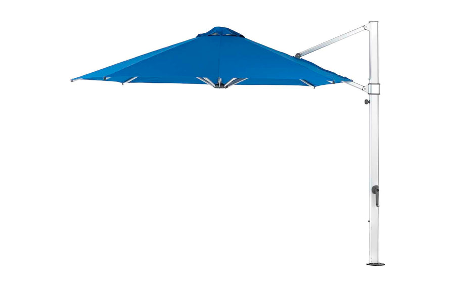 The Ledge Lounger Ultra Cantilever Umbrella - 11 Octagon graces the patio space with its blue canopy and metal frame. Its side pole offers adjustable shade coverage, while the built-in rechargeable light adds evening ambiance.