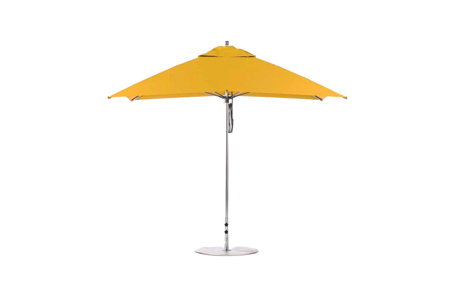 The Essential Fiberglass Umbrella by Ledge Lounger is a 10 square patio umbrella with a metal pole and base. Its simple, modern design includes a wide canopy made from marine-grade fabrics, ideal for outdoor use.
