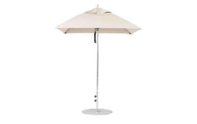 A Ledge Lounger Essential Fiberglass Umbrella - 6.5 Square Pulley in beige stands open on a white background, featuring an aluminum center pole and a round metal base that support its marine-grade fabrics for durable outdoor style.