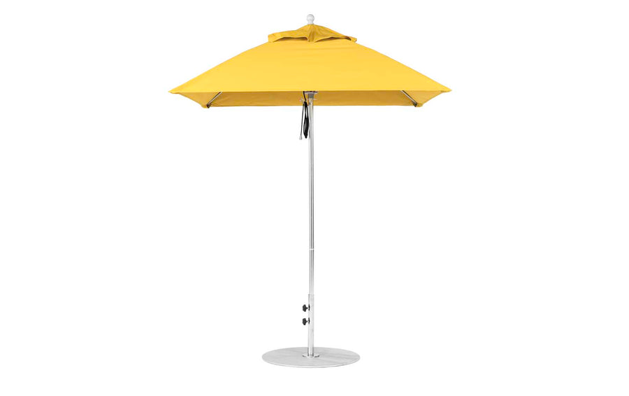 The 6.5 Square Pulley Essential Fiberglass Umbrella by Ledge Lounger boasts a yellow marine-grade canopy with an aluminum center pole, a robust round silver base, and a wind vent for stability, all showcased against a pristine white backdrop.