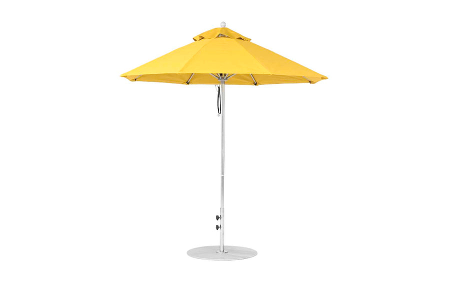 The Ledge Lounger Essential Fiberglass Umbrella features a vibrant yellow octagon canopy, supported by a sleek silver metal pole with a sturdy round base. Made from marine-grade fabrics, this 7.5-foot design is wind-resistant and exudes modern elegance against a plain background.