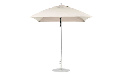 The beige Essential Fiberglass Umbrella by Ledge Lounger boasts a classic design with a 7.5 square canopy made of marine-grade fabric. It features a sleek metal pole and circular base, providing perfect outdoor shade and ensuring compatibility through the Umbrella Compatibility Matrix for versatile use.