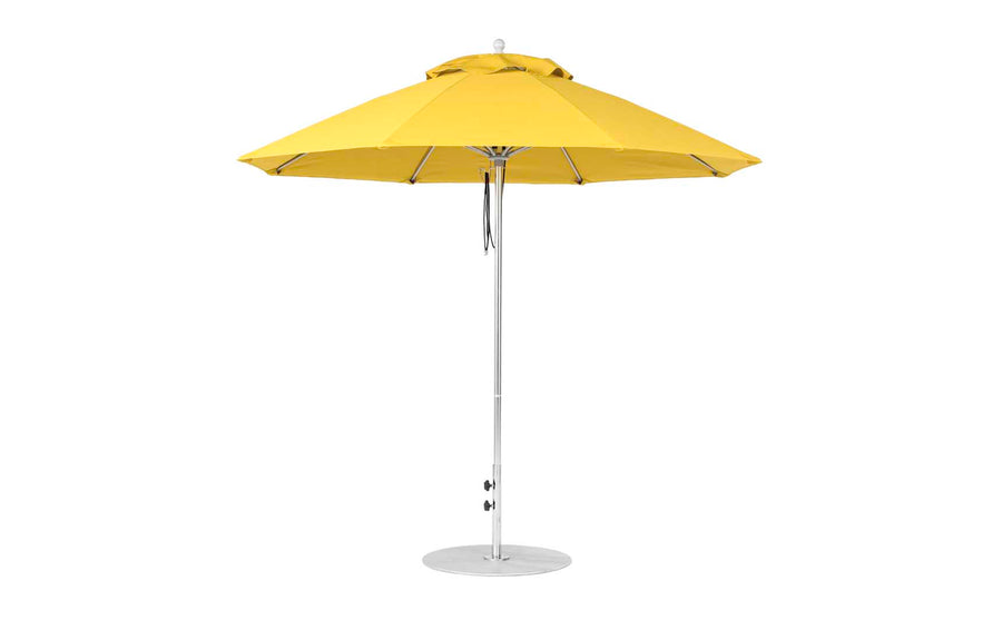 The Ledge Lounger Essential Fiberglass Umbrella - 9 Octagon Pulley features a vibrant yellow marine-grade canopy, supported by a sturdy metal pole and base, elegantly displayed fully open against a pristine white background.