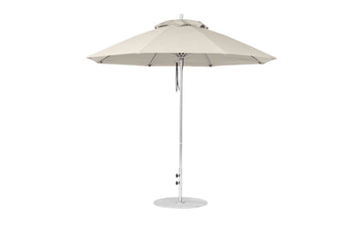 The Ledge Lounger Essential Fiberglass Umbrella, a large beige 9 octagon patio umbrella with a central pole and sturdy round base, features marine-grade fabric and modern metal structure, perfect for any garden or patio setting.