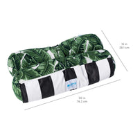 The Ledge Lounger Laze Hammock features a neatly rolled towel with a green leaf pattern, accented by white and black stripes at the base. Ideal for outdoor adventures, it measures 30 (76.2 cm) in width and 15 (38.1 cm) in height.