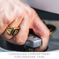 A hand wearing a gold ring turns a valve in the concealed compartment of a propane tank. Captioned, Halo Aglow Bundle by Ledge Lounger.