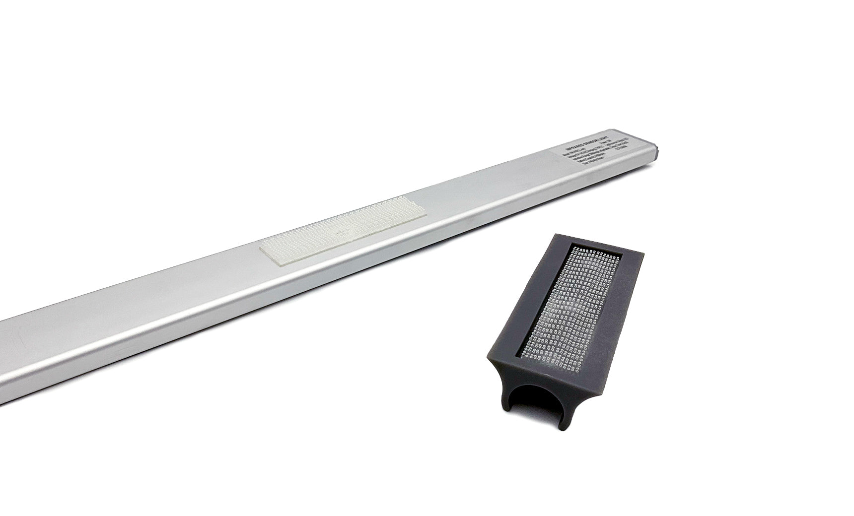 The Umbrella Light by Ledge Lounger includes a sleek silver bar with textured detail, paired with a rechargeable black rectangular attachment featuring a grid pattern. It fits seamlessly onto the bar to enhance your patio, all set against a plain white background.