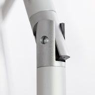 Close-up of a silver-gray metallic hinge with cylindrical components and a pivot mechanism, designed for the 7.5 Octagon Signature 360° Tilt Umbrella by Ledge Lounger, set against a plain white background.