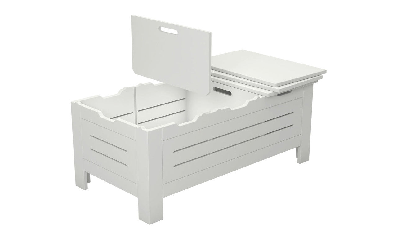 The Ledge Lounger Mainstay Storage Coffee Table is a white wooden box with internal compartments and a partially open slatted lid with a handle. Serving as chic storage, it elegantly stands on four legs.