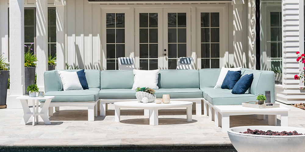 Outdoor sectional with vibrant blue cushions and pillows