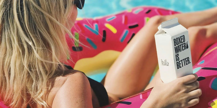 Floating in the pool on a donut float with boxed water