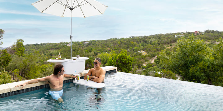 Two men in the pool hanging out around PartyPad by Ledge