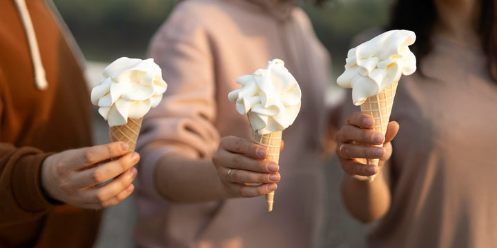 People holding out ice cream cones