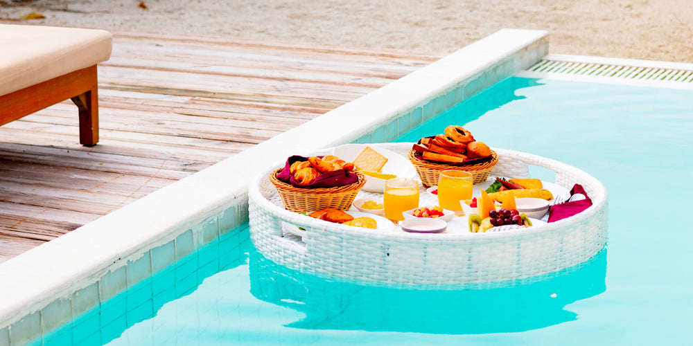 Snacks floating on tray in pool