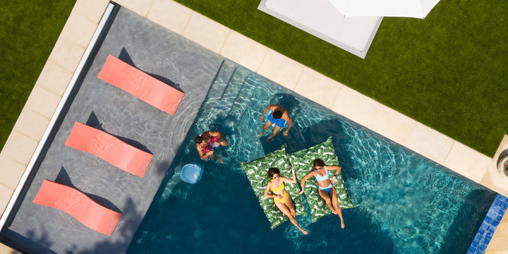 Outdoor scene with furntiure and floats by Ledge