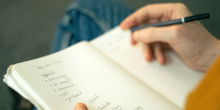 Writing out a checklist for a backyard renovation project