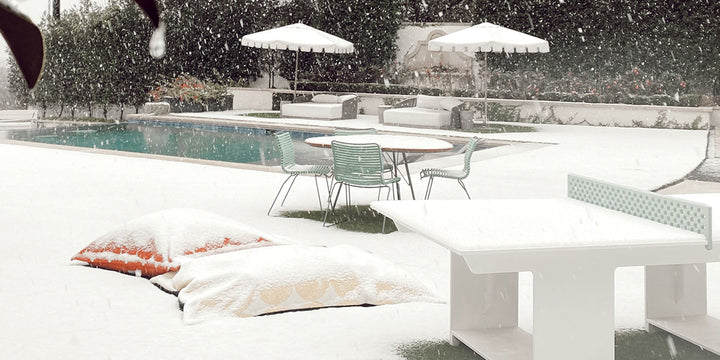 Backyard in the winter with snow on patio furniture