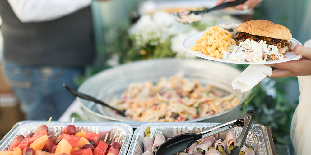 Filling up a plate at an outdoor buffet