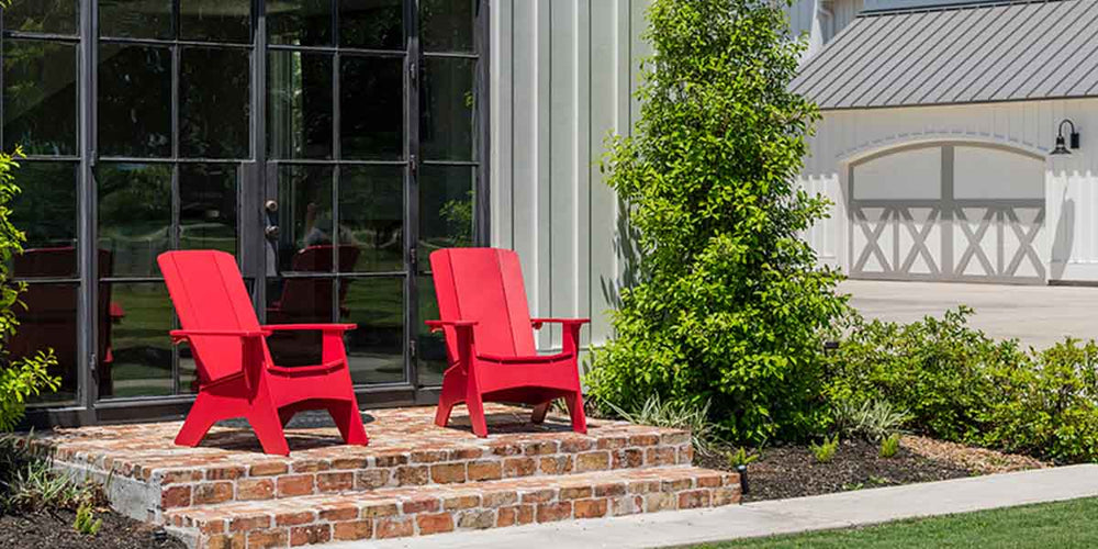 Red Adirondack chairs in the sun